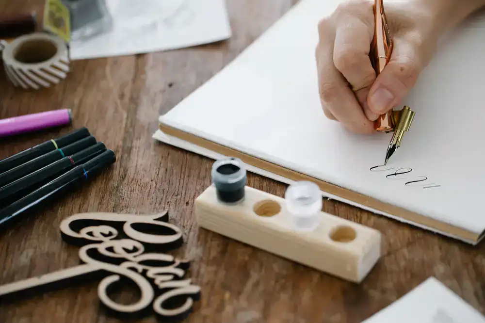 Students practicing pen strokes during a calligraphy workshop