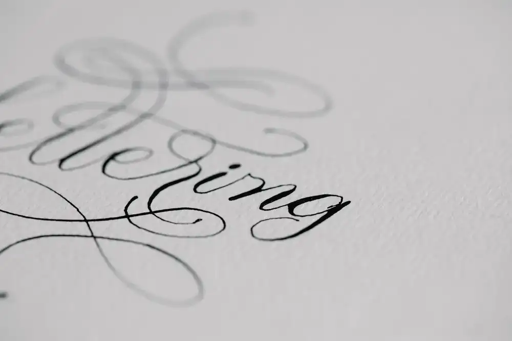 Student writing elegant copperplate script